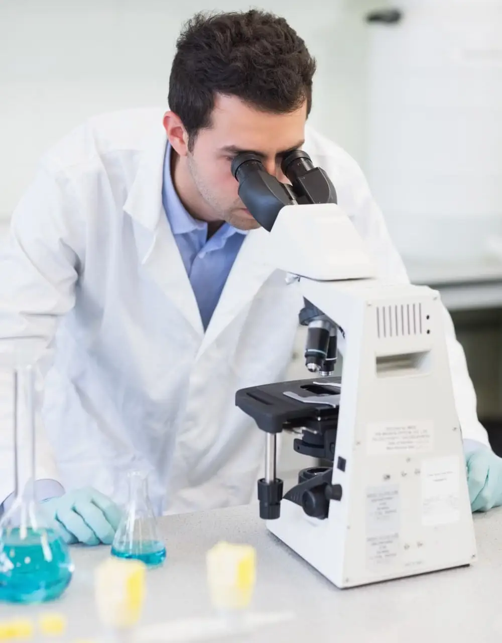 laboratory scientist analyzing samples using a microscope in a research laboratory